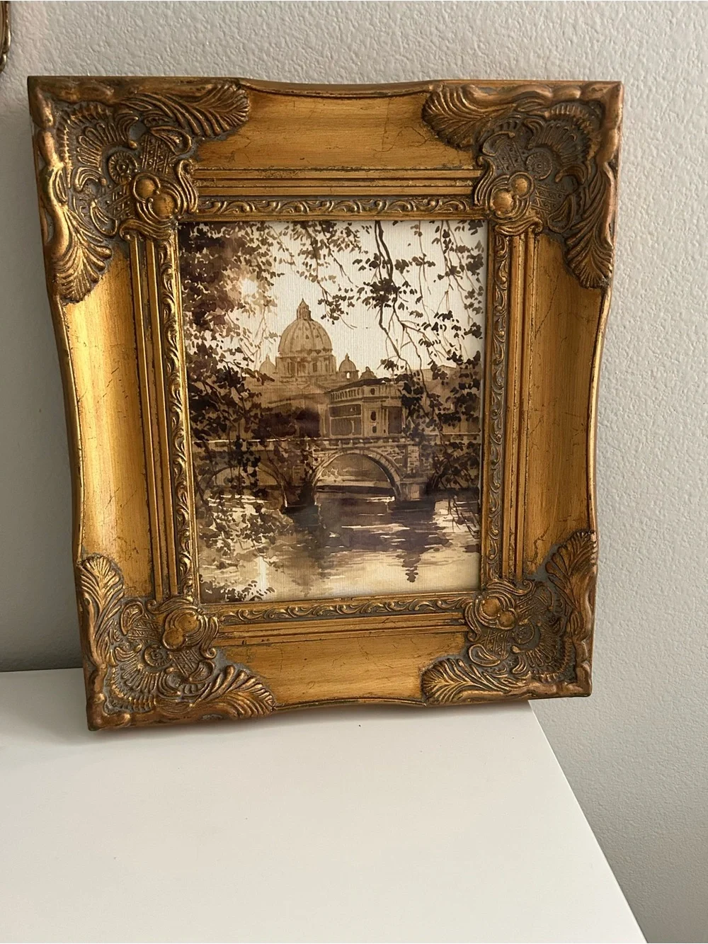 Framed art in gilded ornate frame